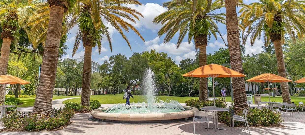 student walking by fountain on Coral Gables campus