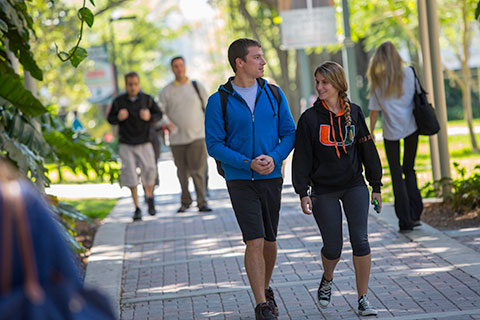 Two Students Walking Through Campus